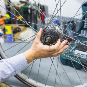man-s-hand-repairing-bicycle-tire-workshop
